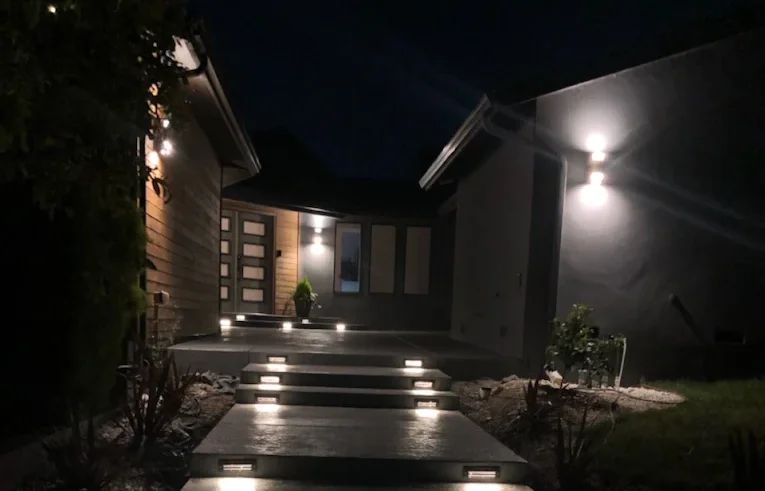 Concrete walkway and steps with integrated low-voltage lighting at night