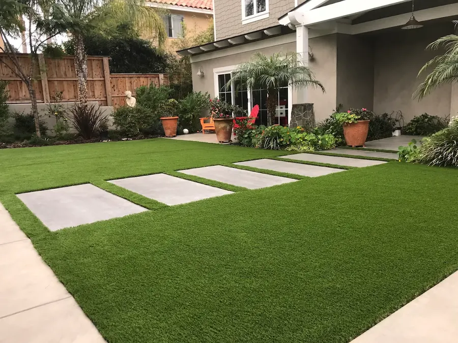Artificial turf lawn with concrete paver stepping pads